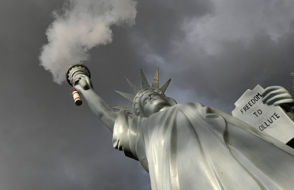 A replica of the Statue of Liberty by Danish artist Jens Galschiot emits smoke in a park outside the 23rd U.N. Conference of the Parties climate talks in Bonn, Germany.