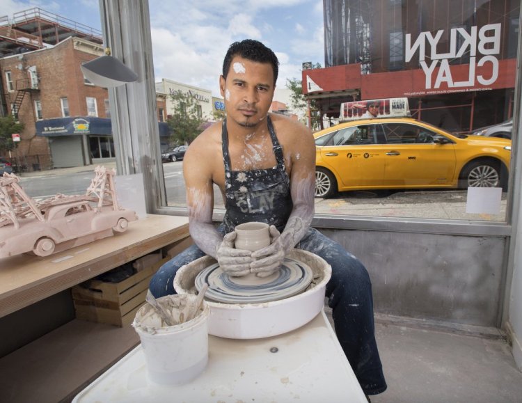 Luis Marte poses for the NYC Taxi Drivers Calendar in New York. Sales of the tongue-in-cheek calendar featuring 12 New York City cabbies benefit a social-service organization.