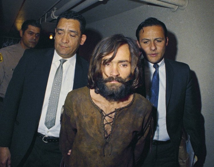 In this 1969 file photo, Charles Manson is escorted to his arraignment on conspiracy and murder charges in connection with the Sharon Tate murder case.