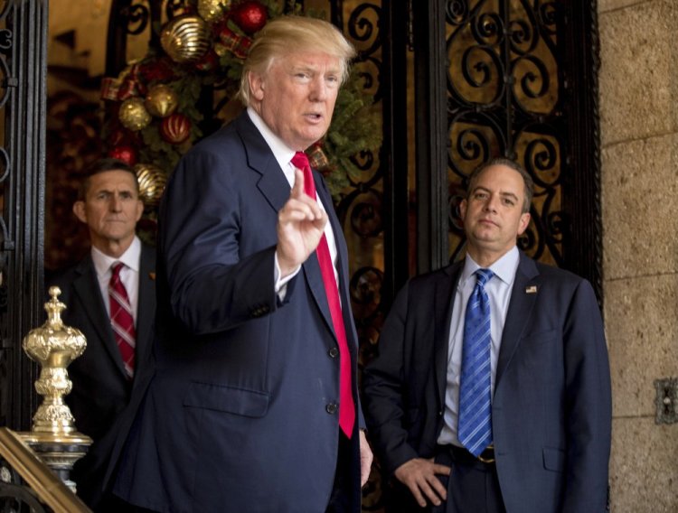 President-elect Donald Trump, accompanied by Chief of Staff Reince Priebus, right, and retired Gen. Michael Flynn, a senior adviser to Trump, speaks to members of the media at Mar-a-Lago, in Palm Beach, Fla., on Dec. 21, 2016.