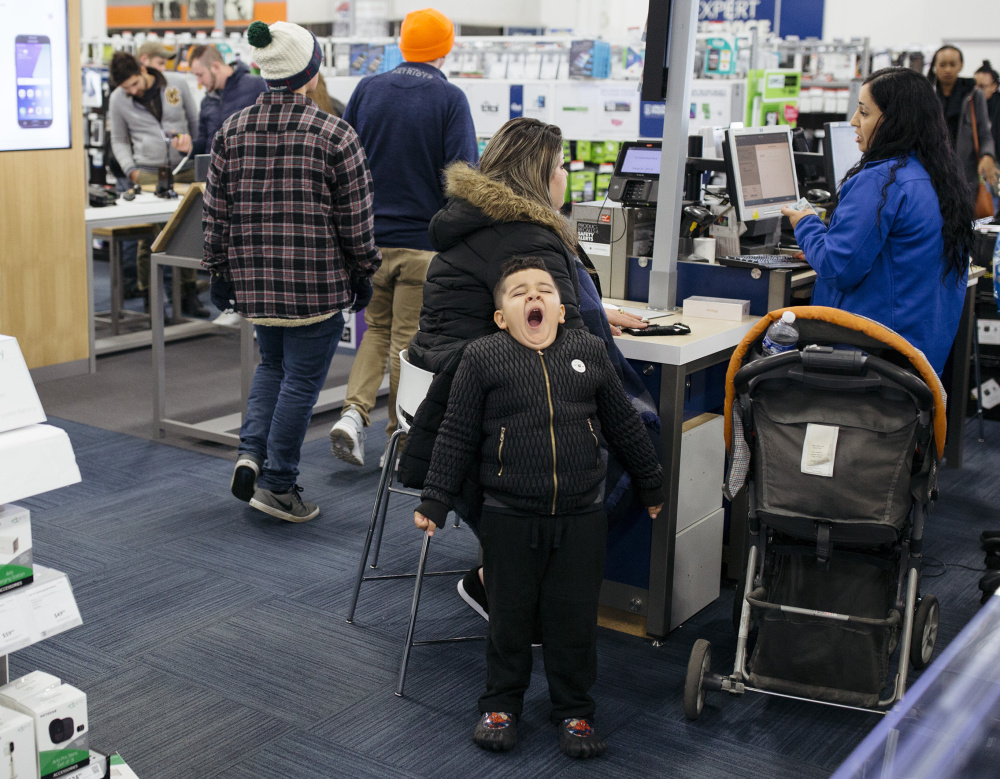 SOUTH PORTLAND, ME - NOVEMBER 24: Yousef, 5, lets out a yawn as he waits for his mother to finish shopping at Best Buy in the Maine Mall just after midnight on Black Friday. (Staff photo by Brianna Soukup/Staff Photographer)
