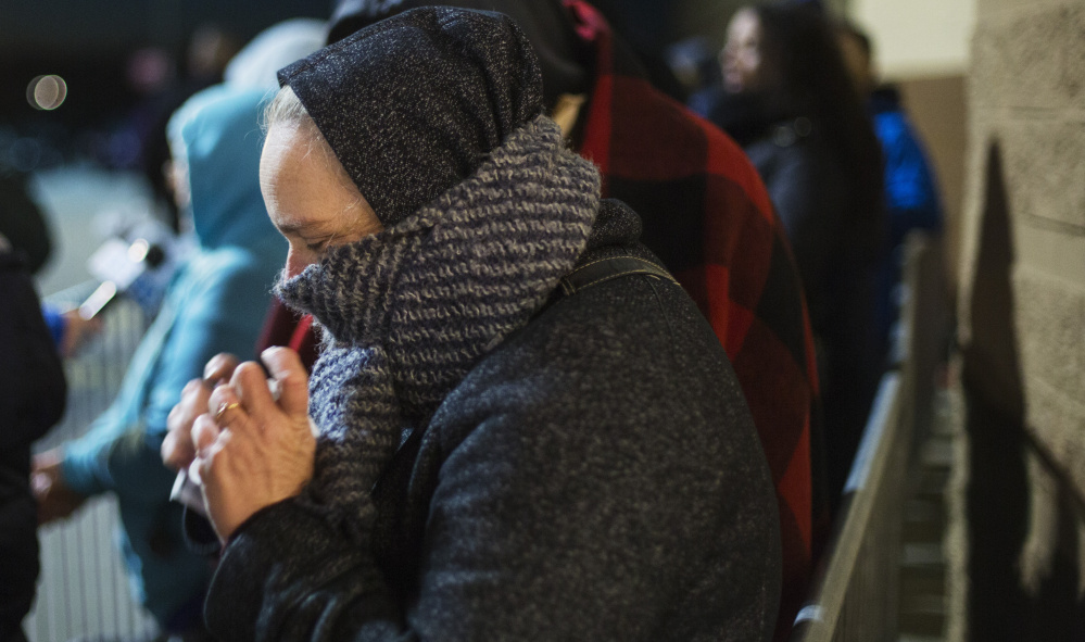 SOUTH PORTLAND, ME - NOVEMBER 24: Carol Rickett of Portland uses handwarmers while waiting in line for early Black Friday shopping at Target. (Photo by Derek Davis/Staff photographer)