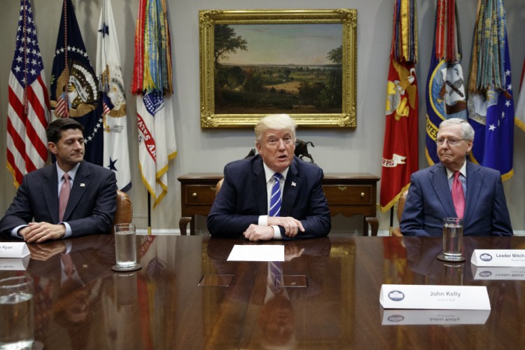 House Speaker Paul Ryan, R-Wis., left, and Senate Majority Leader Mitch McConnell, R-Ky., right, listen as President Trump speaks during a meeting with Congressional leaders and administration officials on tax reform. A new CBO scoring of the bill shows it will hurt poor Americans more than previously believed.