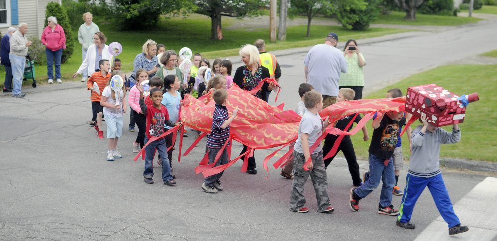 T.C. Hamlin School students parade through Randolph in 2016 to celebrate the number of books they read during the school year. Enrollment at the Randolph elementary school has declined to 44 students, prompting the school district to consider whether to keep it open or close it.