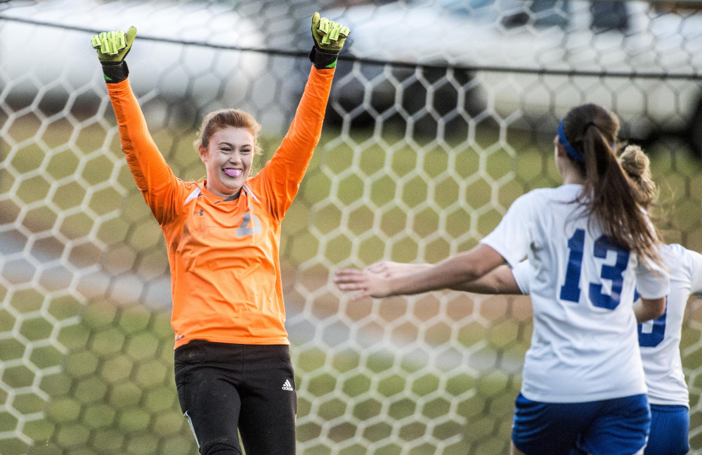 Madison goalie Lauren Hay raises her hands in celebration after making two key saves in a shootout against Traip in a Class C girls south semifinals game in Madison on Oct. 27.