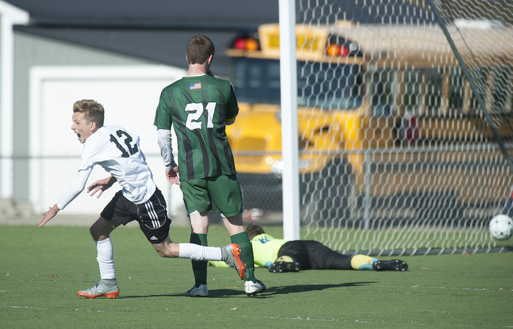 Wyatt Lambert runs to celebrate with his Maranacook boys soccer teammates after Silas Mohlar scored with 20 seconds left in regulation to give the Black Bears a 1-0 victory over Fort Kent in the Class C state title game Saturday morning at Hampden Academy.