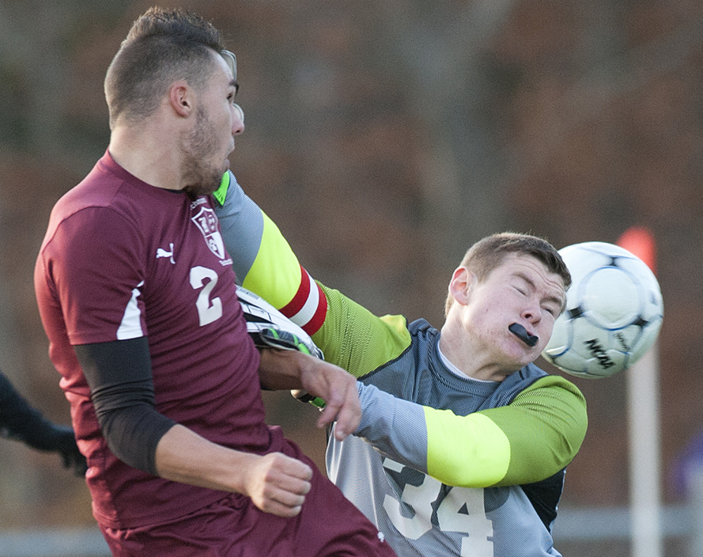 Richmond's Ben Gardner, left, collides with Bangor Christian goalie Jeremiah McNally durig the Class D state championship game Saturday at Hampden Academy.