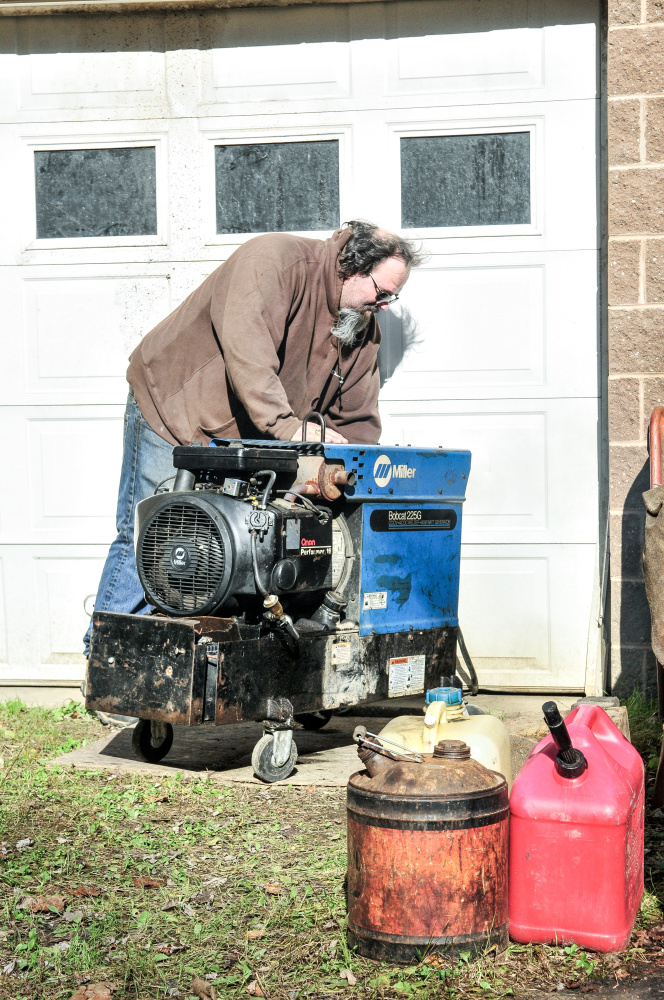 Mike Gorman starts his generator Saturday at his home on Mount Pisgah Road in Wayne.