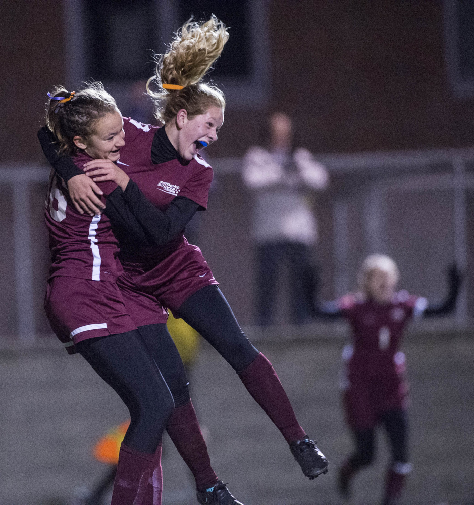 Richmond's Bryannah Shea, right, jumps into the arms of Abigail Johnson after scoring the second goal of the Class D state game against Ashland on Saturday at Hampden Academy.