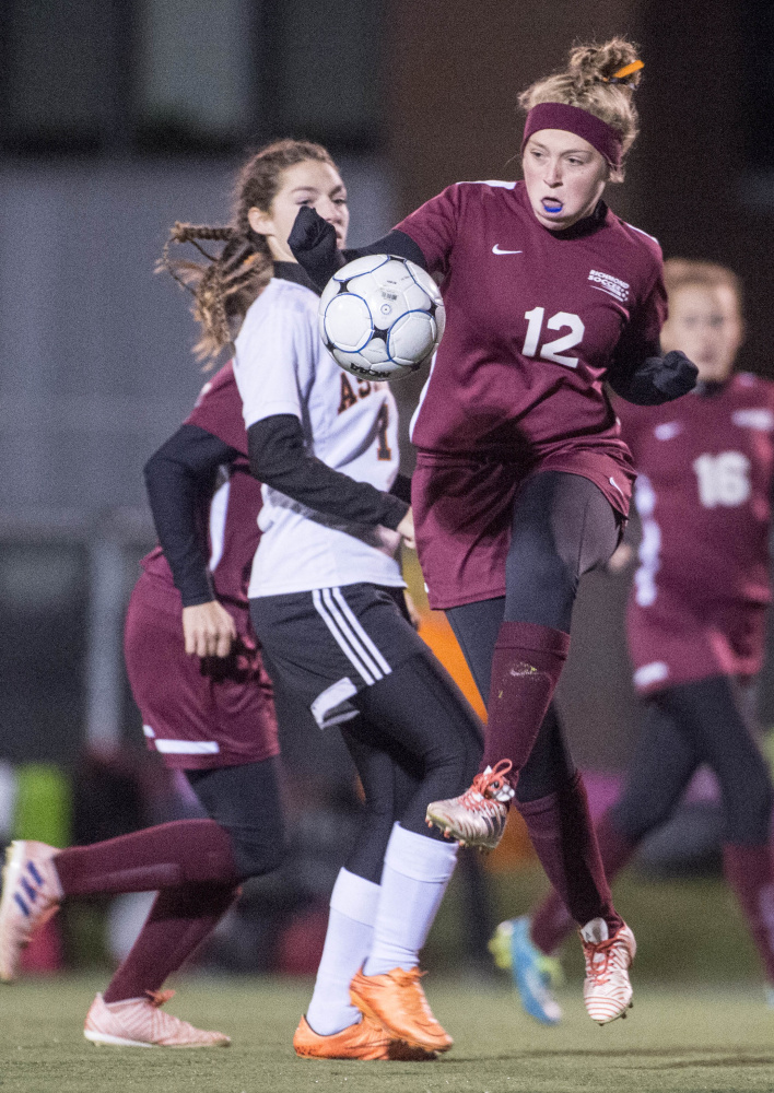  Richmond's Ashley Brown (12) battles for the ball with Ashland's Danni Carter (1) in the Class D state championship game Saturday in Hampden.