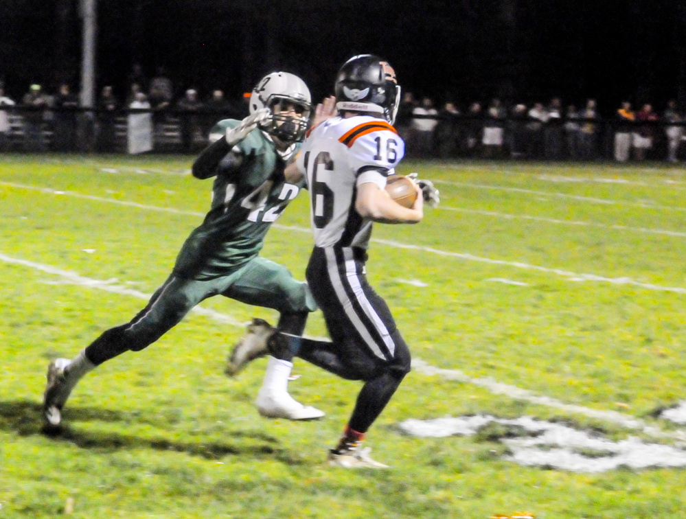 Gardiner running back Collin Foye tries to out-run Leavitt defensive back Caleb Brown during a Class C South semifinal game Friday in Turner.