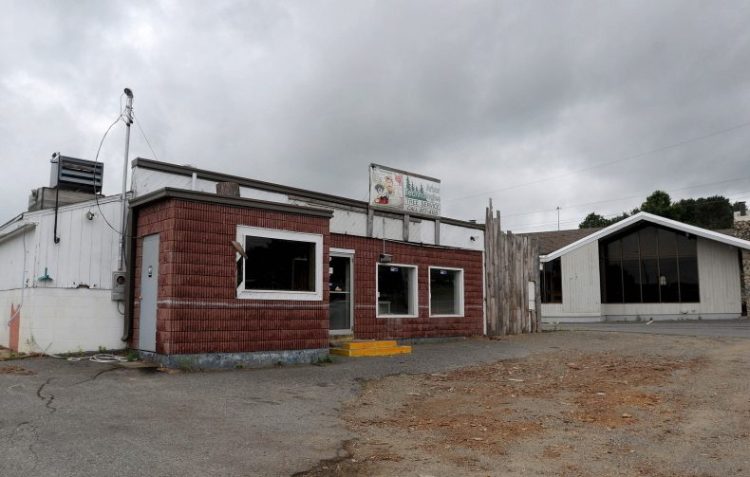 The Weathervane Restaurant and a former car wash and arborists building on Kennedy Memorial Drive sit vacant in August 2015. Marden's Surplus & Salvage owners are proposing to build a strip mall on that property.