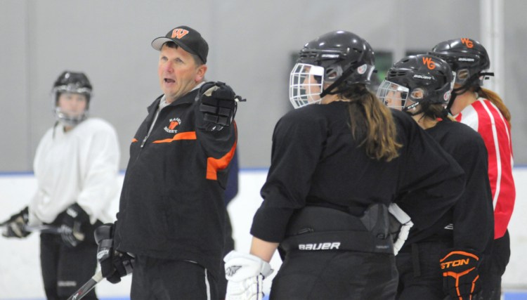 First-year Winslow/Gardiner coach Alan Veilleux instructs players during a drill Tuesday night at the Camden National Bank Ice Vault in Hallowell.