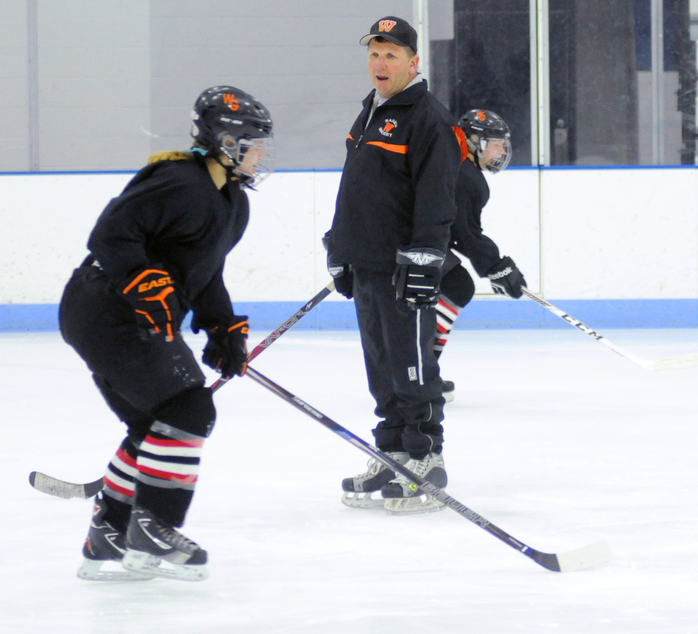 New Winslow/Gardiner girls hockey coach Alan Veilleux instructs players  during a drill Tuesday night at the Camden National Bank Ice Vault in Hallowell.