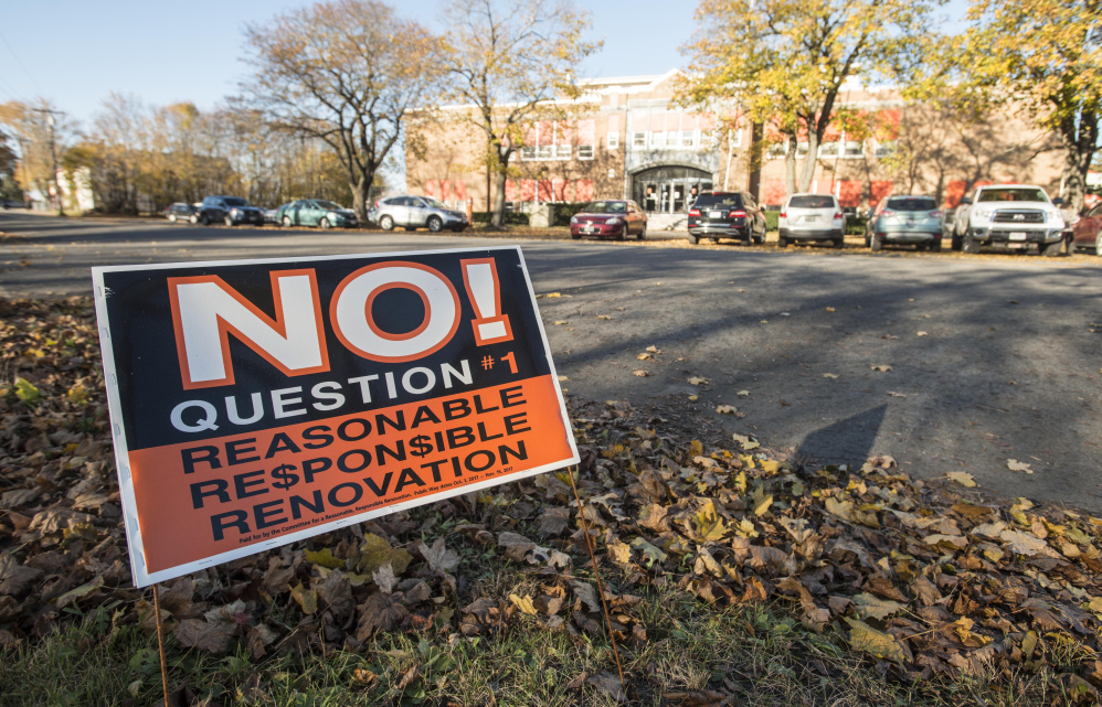 A political sign urging voters to vote "no" on local Question 1 stands across the street from Winslow Junior High School on Wednesday in Winslow.