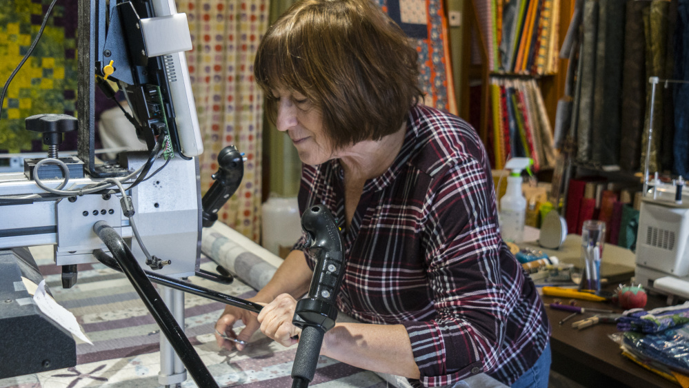 Lynn Irish works on her long arm quilting machine Saturday at her shop on Water Street in Hallowell. Irish is planning on moving a few doors down from the current location, doubling her space and providing the opportunity for more classes and workshops.
