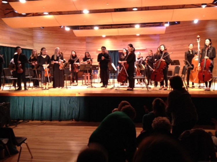The Philharmonia Boston Orchestra and students from the Snow Pond Youth Symphony and Maine Suzuki Association receive a standing ovation Nov. 4 at the Snow Pond Center for the Arts in Sidney following a performance of Wolfgang Amadeus Mozart's Divertimento No. 1 in D Major,"conducted by Jinwook Park, center.