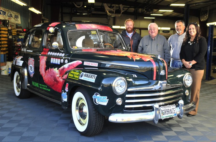 From left, Patrick Wright, Peter Prescott, Ed Chapman and Katie Doherty pose with Prescott's 1948 Ford four-door convertible on Wednesday in Gardiner.
