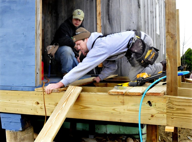 Sam Cantlin, front, and Joe Taylor work on a wheelchair ramp at the Palermo Community Center on Sunday.