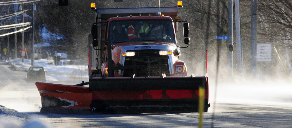 A city plow truck clears drifting snow that was covering Hospital Street on Dec. 15, 2016, in Augusta, where city staff are working to employ new strategies to help clear city streets.