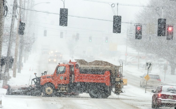 An Augusta snow plow crosses Western Avenue at Sewall Street during a nor'easter on March 14 in Augusta, where city staff are looking for ways to improve snow removal.