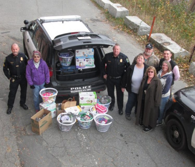 Skowhegan police Chief David Bucknam, center, with Sgt. Joel Cummings, left, and other volunteers collected needed items for the Somerset County domestic violence shelter during October, which waas domestic violence awareness month.
