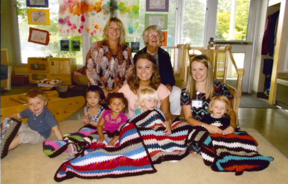 Children in the KVCAP Early Head Start program with afghans donated by ABC Quilts. In front from left are Jesse Jones, Mandy Weng, Isabella Quinn, Alessandro Susinetti, Ronin. In the middle are Eucare infant toddler teachers Leeannza Delosh, left, and Danielle Plossay. In back, from left, are Educare Associate Director Rhonda Kaiser and Connie Warren of ABC Quilts.