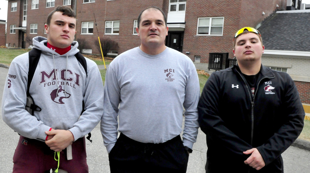 Football is all in the family for Maine Central Institute as head coach Tom Bertrand, center, is flanked by his sons, Adam, left, and Alex. Adam plays running back while Alex is an assistant coach.