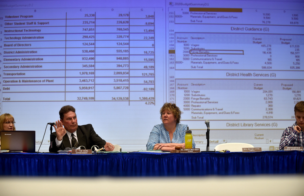 Dr. Tom Ward, left, superintendent of RSU 9 answers questions regarding the school budget during an RSU 9 budget meeting with Jennifer Zweig Hebert, right, of Starks, at Mt. Blue High School in Farmington on April 27. Tuesday the district board voted unanimously to apply to join a regional service center, a necessary step to qualify for the state to fund administration in the next few years. The district already shares services with several other districts.
