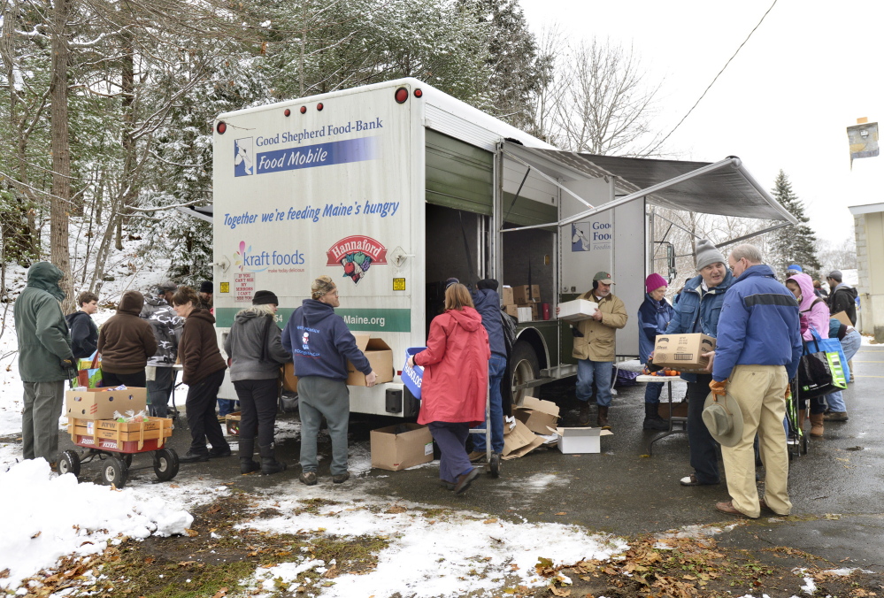 A line forms around the mobile food truck behind the Grace Episcopal Church in Bath. Tuesday, Nov.26, 2013. John Patriquin/Maine Sunday Telegram.