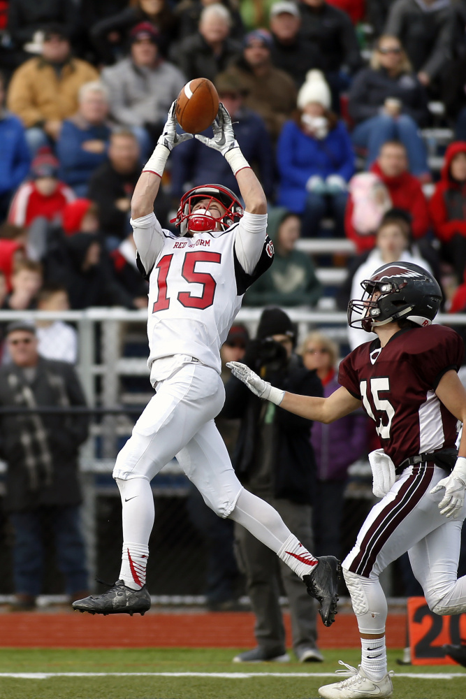 Scarborough wide receiver Cody Dudley hauls in a pass as Windham linebacker defends during the Class A football championship game Saturday at Fitzpatrick Stadium in Portland.