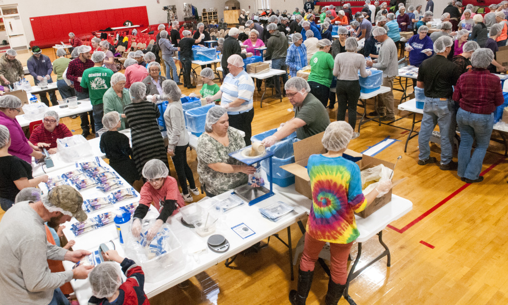 Volunteers bag up fortified rice at Cony High School in Augusta in an event run by Feed My Starving Children, a Christian nonprofit organization that coordinates the packaging and distribution of food to people in developing nations.