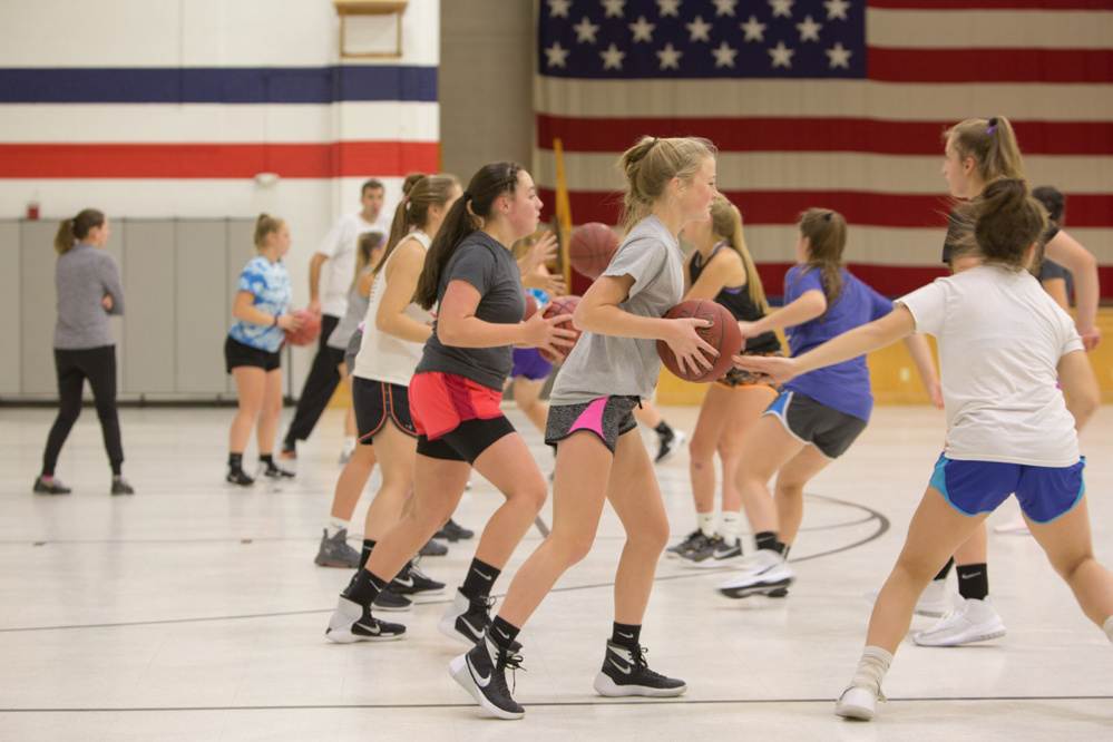 The Gardiner Area High School girls basketball team works through a drill during the first day of practice Monday at the Augusta Armory.