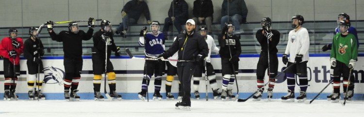 Kennebec RiverHawks coach Jon Hart, center, leads his team through practice on Monday at Colby College's Alfond Rink in Waterville.