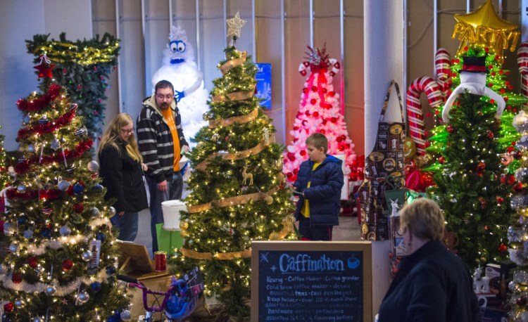 People browse among the many Christmas trees on display last Friday at the Sukeforth Family Festival of Trees at the Hathaway Creative Center in Waterville.