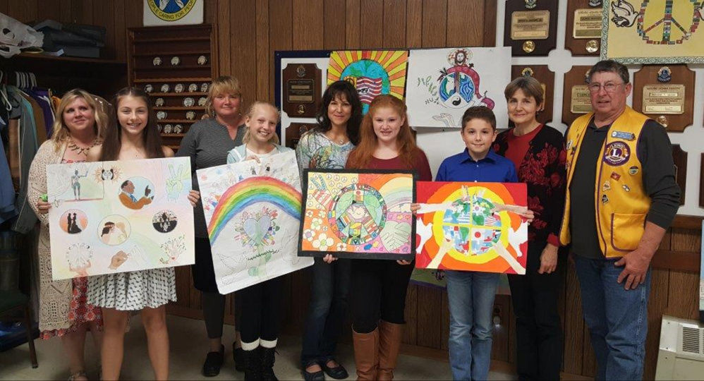 Winners of the Peace Poster Contest with their art teachers, from left, are Holly Hilton and Jenna Perkins, Whitefield; Rachel Richmond and Abby St. Cyr, Jefferson; Sandy Dunn and Liberty Kimball, Chelsea; and Damon Wilson and Jenny Keller, Windsor; and Lion Barry Tibbetts.