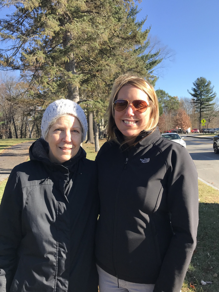 Suzanne Callahan, left, and Nicole Harbaugh pause while on a walk Tuesday in Augusta to talk about their holiday shopping habits.
