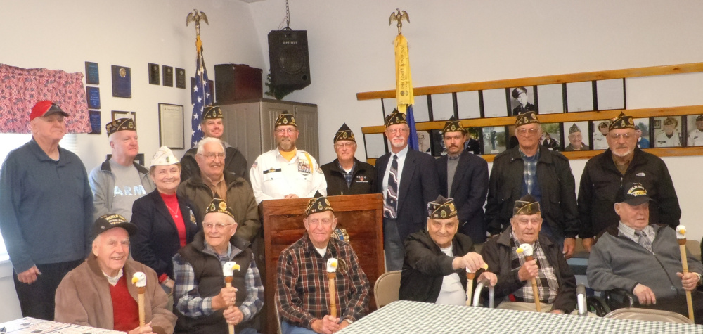 William R. Bold American Legion Post 181, Litchfield, held a special Veterans' Day event on Nov 11. The Post honored World War II and Korean War veterans by presenting them with Eagle Canes. The canes are handmade by Donna and George Gunning and include the veteran's branch and dates of service, name, and all medals received. From left are William "Bill" Quackenbush, WWII; Harold Blen, WWII; George Perry, Korea; Keith Estabrook, WWII/Korea; Malcolm Harvey, WWII/Korea/Vietnam; and Leo Small, WWII. Back from left, are Post 181 members Randall Furbish, Ron Dixon, Debra Couture, Ernie Rowe, Scott Bailey, Roger Line, Glenn Bowman, Greg Couture, Michael Sherman, Normand Bernier and Carlton Tripp.