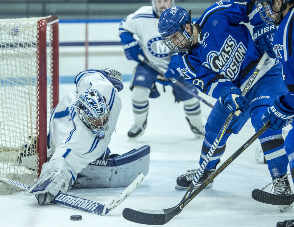 Colby College goalie Andrew Tucci makes a save against UMass Boston's Zach Bross (18) at Colby College in Waterville on Saturday.