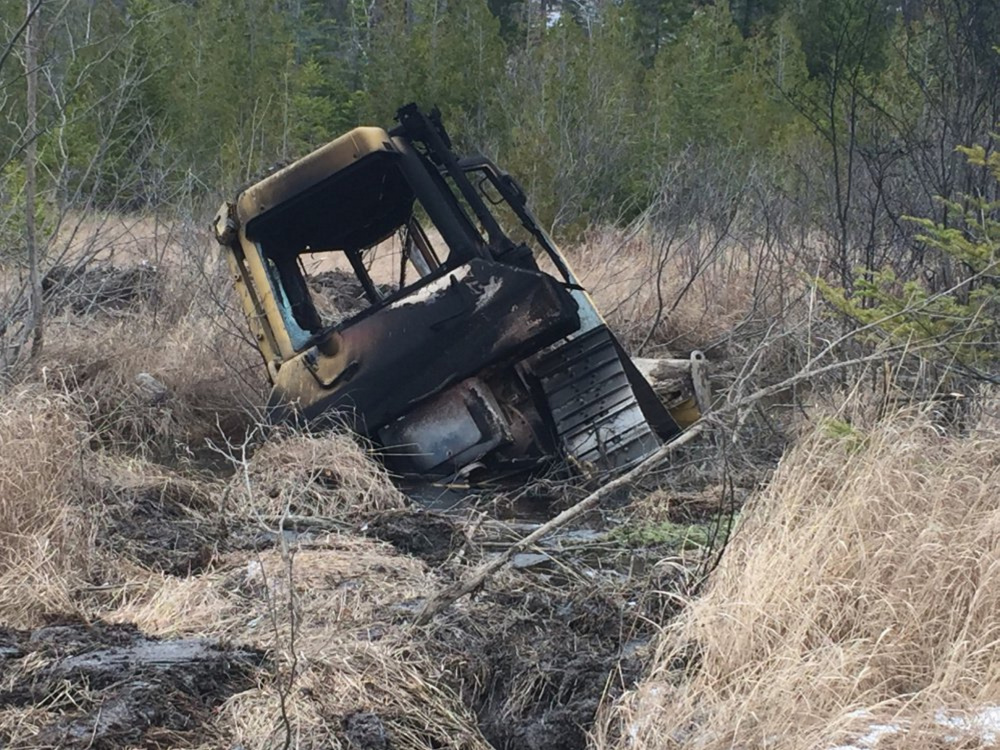This bulldozer, owned by Cousineau Wood Products of Wilton, was found by hunters earlier this month off Beech Hill Road in Sandy River Plantation, where it had been set on fire.