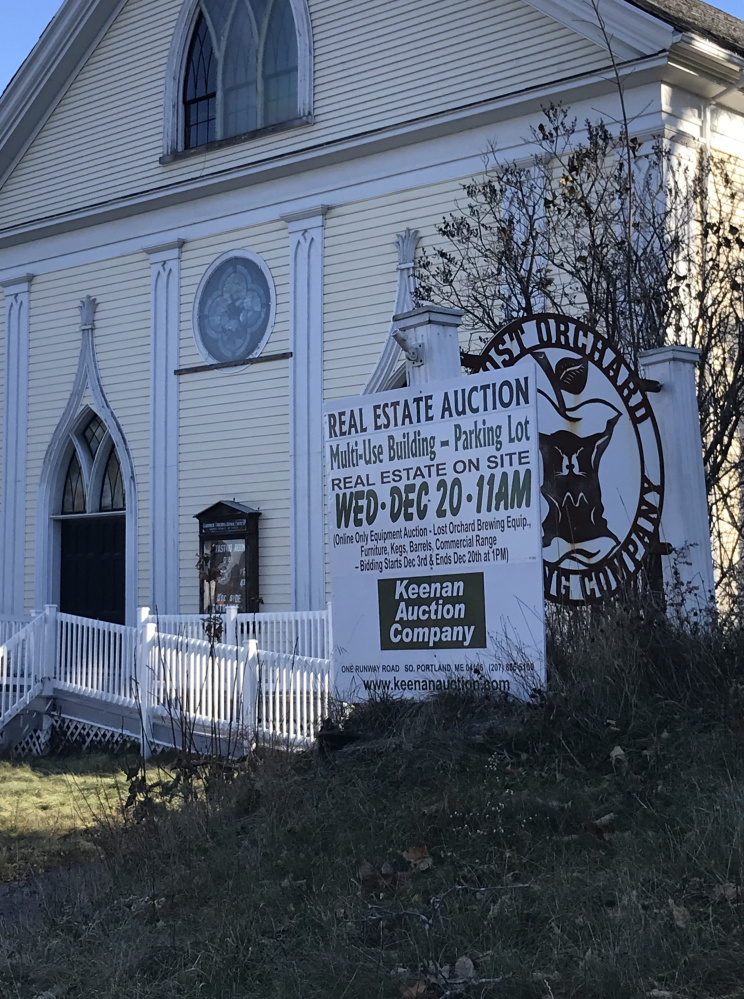 An auction sign outside Lost Orchard Brewing Company in Gardiner on Tuesday. The church is expected to be auctioned to the highest bidder on Dec. 20.