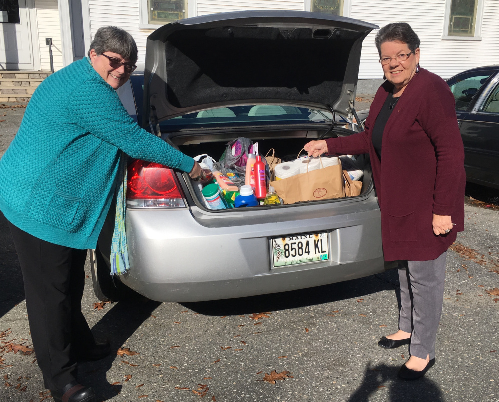 Kappa members Mary Whitten, of Gardiner, left, and Betty-Jane Meader, of Waterville, load the car for delivery of a variety of items to The Essentials Closet.