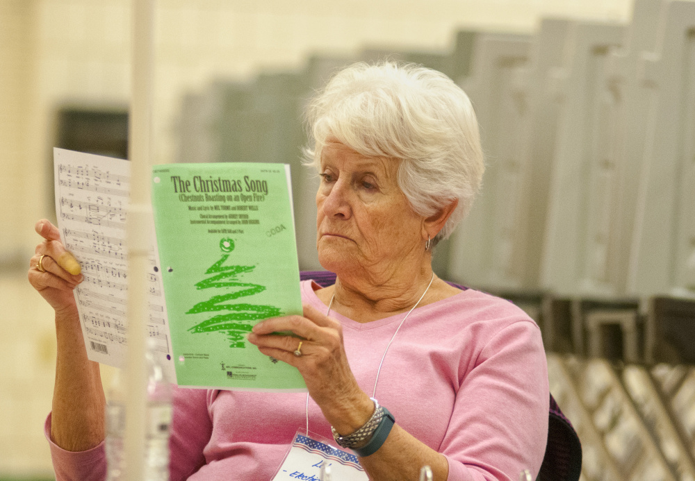 Election Clerk Lillian Stresser reviews her sheet music for a chorus while waiting for voters Tuesday at the Winthrop Town Office. Stresser is part of the CODA Chorus, which will be holding its 50th annual holiday celebration featuring two concerts at 3 p.m. and 7 p.m. Dec. 9 at Hope Baptist Church on U.S. Route 202 in Manchester.