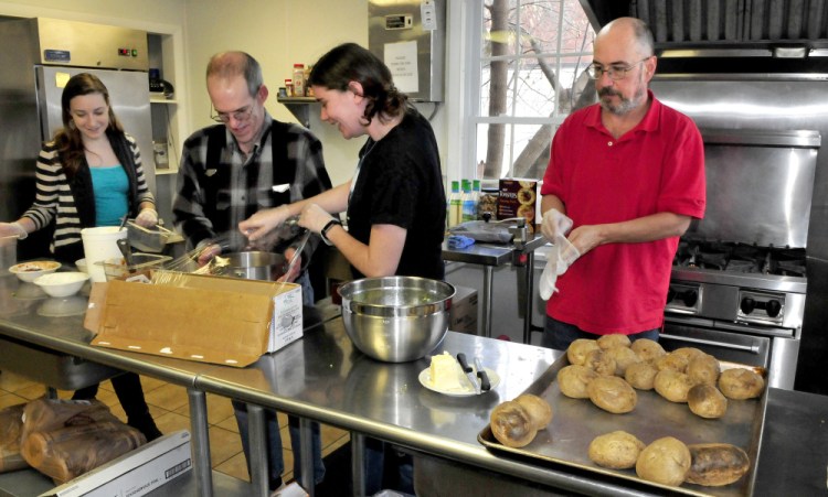 High Hopes Clubhouse unit coordinators Kristen Cormier, left, and Kaelee Tanner, center, work with members Richard Gilbert, second from left, and Scott Dubay after lunch Wednesday at the Waterville organization. The organization has been recognized for having 79 percent of its members employed.