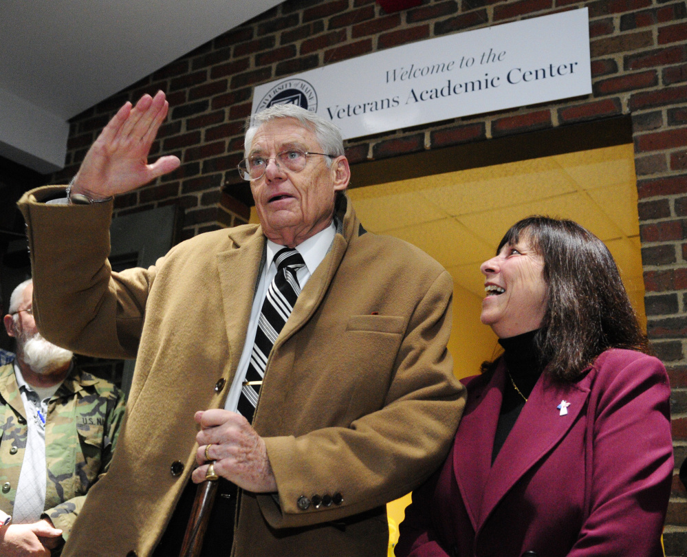 Robert Fuller, left, salutes after giving brief remarks Thursday at the opening of the new Veterans Academic Center at the University of Maine at Augusta. Amy Line, the school's coordinator of veterans' affairs, is at right. Fuller, a former Navy captain, and his family foundation, The Windover Foundation, donated most of the money for the project.