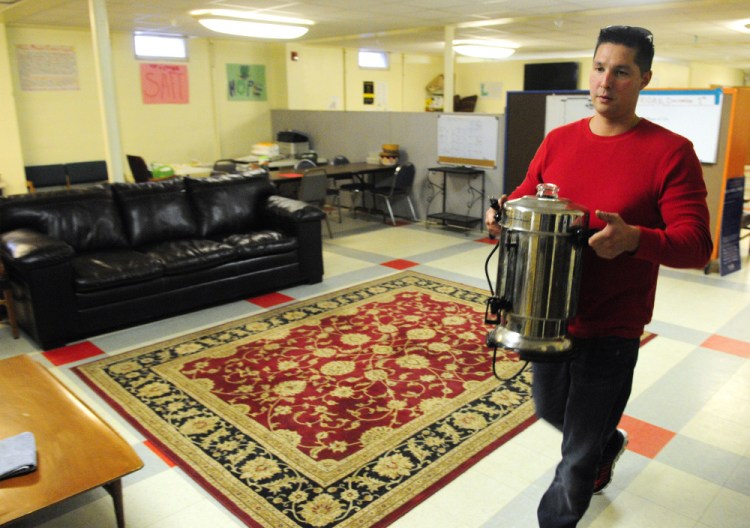 Dan Leu, volunteer program manager, carries a coffee pot toward a sink Thursday as he cleans it to get ready for opening of the Augusta Community Warming Center on Friday at St. Mark's Parish Hall in Augusta. Leu said that the center sometimes makes almost 100 cups of coffee a day.