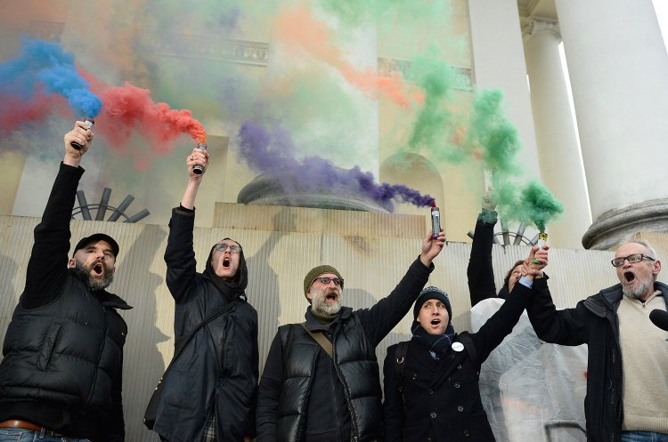 Civic rights activists burn flares in front of City Hall in Warsaw, Poland, on Monday to protest what they saw as authorities' failure to respond properly to the behavior of nationalists during the Independence March on Saturday.