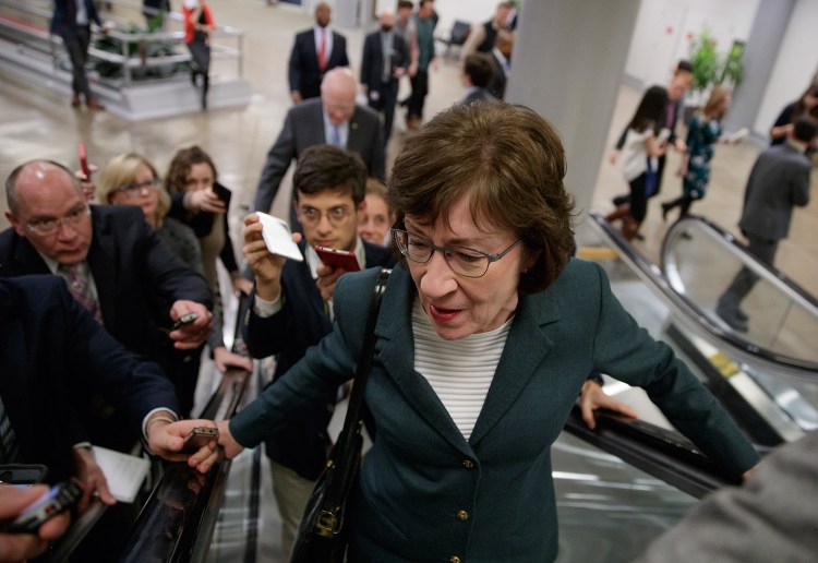 With reporters looking for updates, Sen. Susan Collins, R-Maine, and other senators rush to the chamber to vote on amendments Thursday as Republican leaders work to craft their sweeping tax bill.