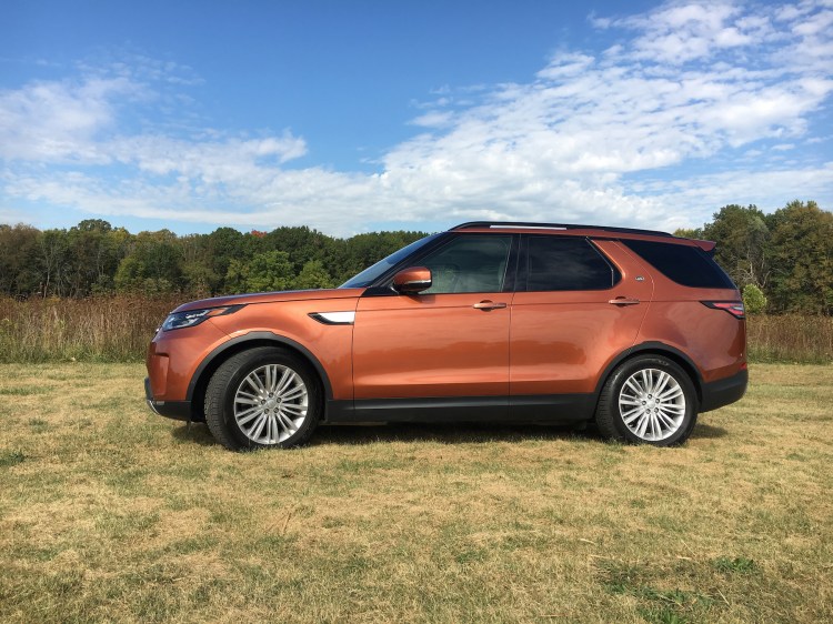 The fifth-generation 2017 Land Rover Discovery in Namib Orange is a luxury three-row SUV powered by a V-6 diesel engine with all sorts of technological conveniences that help define luxury. 