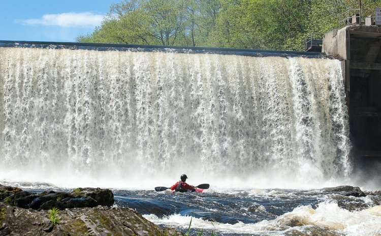 Ryan Galway makes his way onto the Little Androscoggin River in Auburn behind Barker Mill Arms in May. The trip was organized to explore the recreational potential of the river just below the dam. 